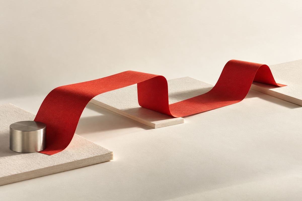 IRG MEDIA 1 A continuous red paper ribbon connects a series of ivory paper surfaces